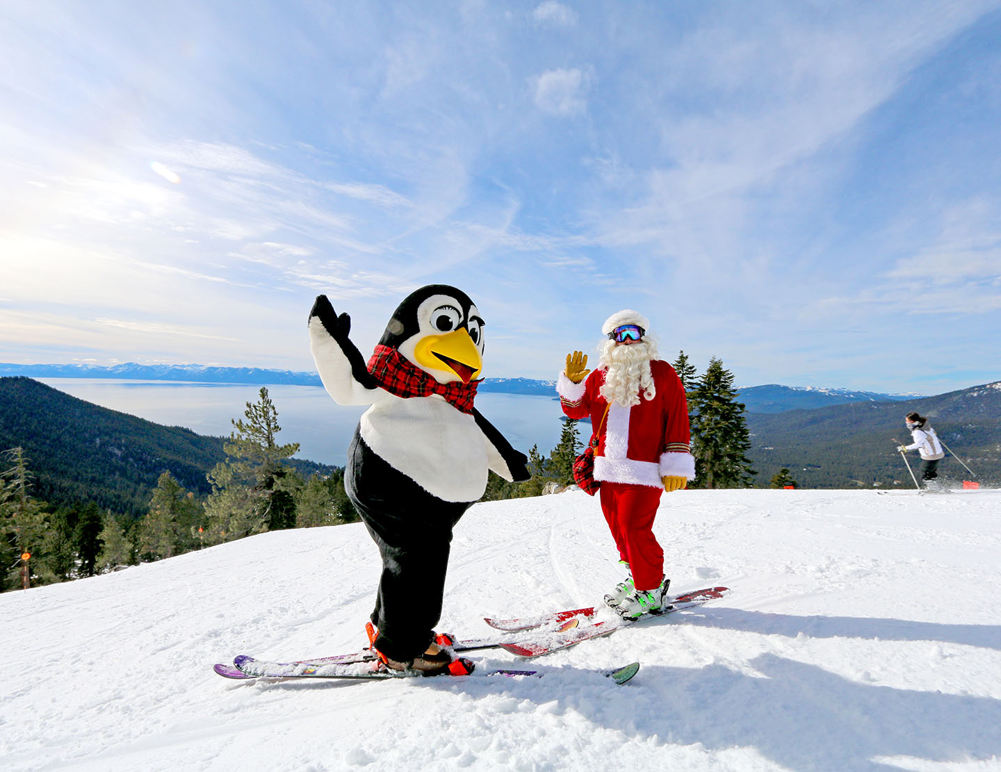 Santa Claus and Penguin Pete skiing on Crystal Ridge